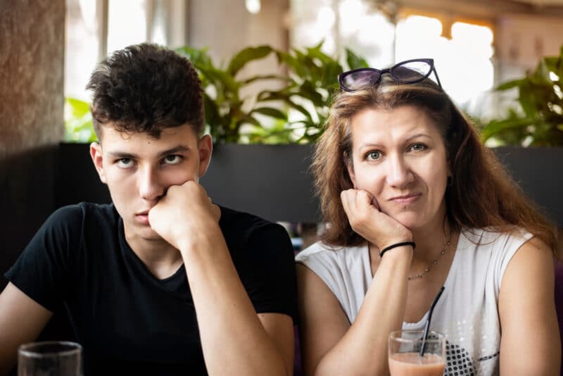 Woman,With,Her,Teenage,Son,In,A,Cafe,Drink,Juice
